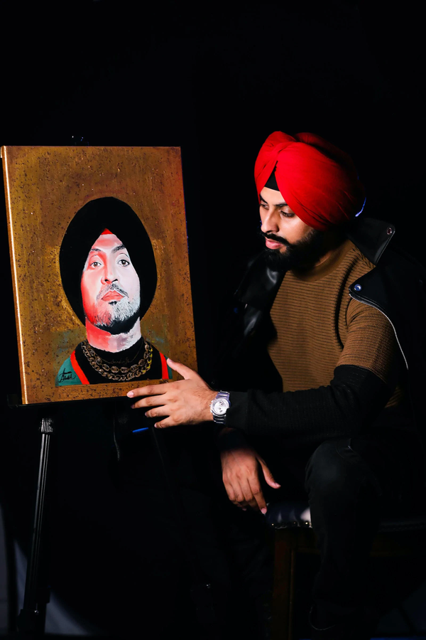 Diljit Dosanjh with his hand-painted portrait by Armaan Bhattal